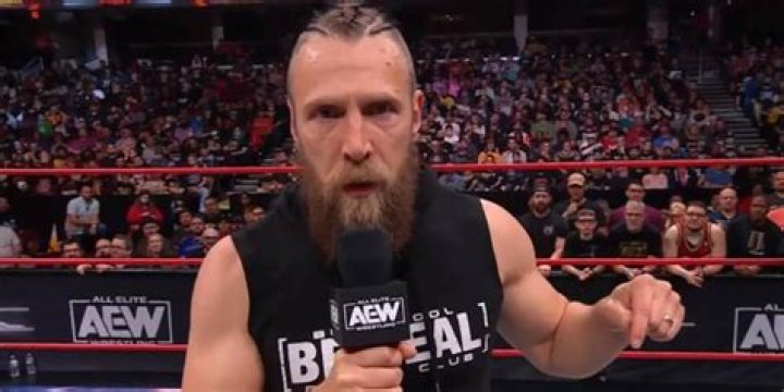 bryan danielson on the mic, looking down the camera