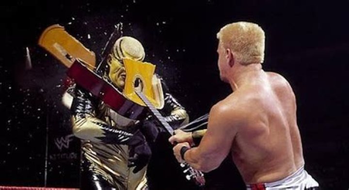Jeff Jarrett smashes a guitar over Goldust's head