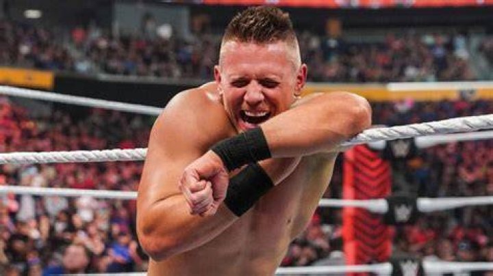 the miz leaning on the ropes and laughing