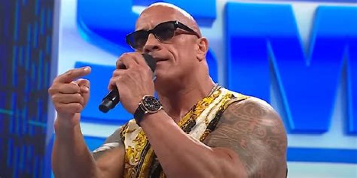 The Rock holding a microphone