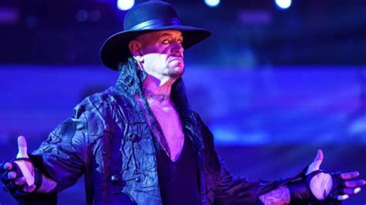 the undertaker posing and rolling his eyes back